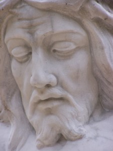 Sadness of Jesus statue in cemetery - focus for meditation on fasting